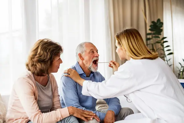 Nurse visiting elderly couple at home